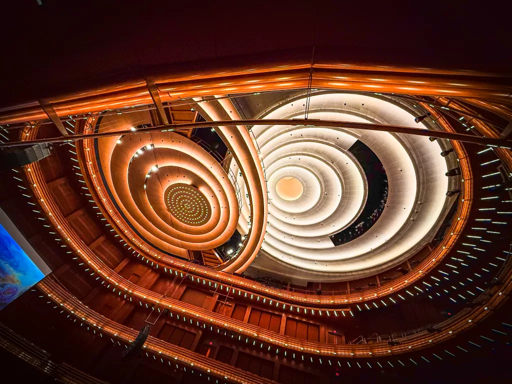 “A stunning spiraling ceiling at Steinmetz Hall, Dr. Phillips Center for the Performing Arts in Orlando, showcasing the beauty of curves in architecture.”